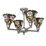 Lit view of 4 light chandelier with pink floral Tiffany-style stained glass shades.