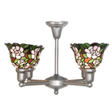 Side view of 4 light chandelier highlighting curved arms and floral glass shades.