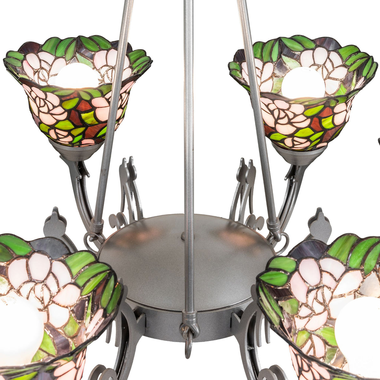 Close-up of chandelier arm with curved metal support and stained glass floral shade.