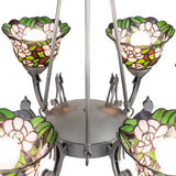 Close-up of chandelier arm with curved metal support and stained glass floral shade.