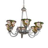 Lit view of chandelier with glowing blush pink stained glass floral shades.