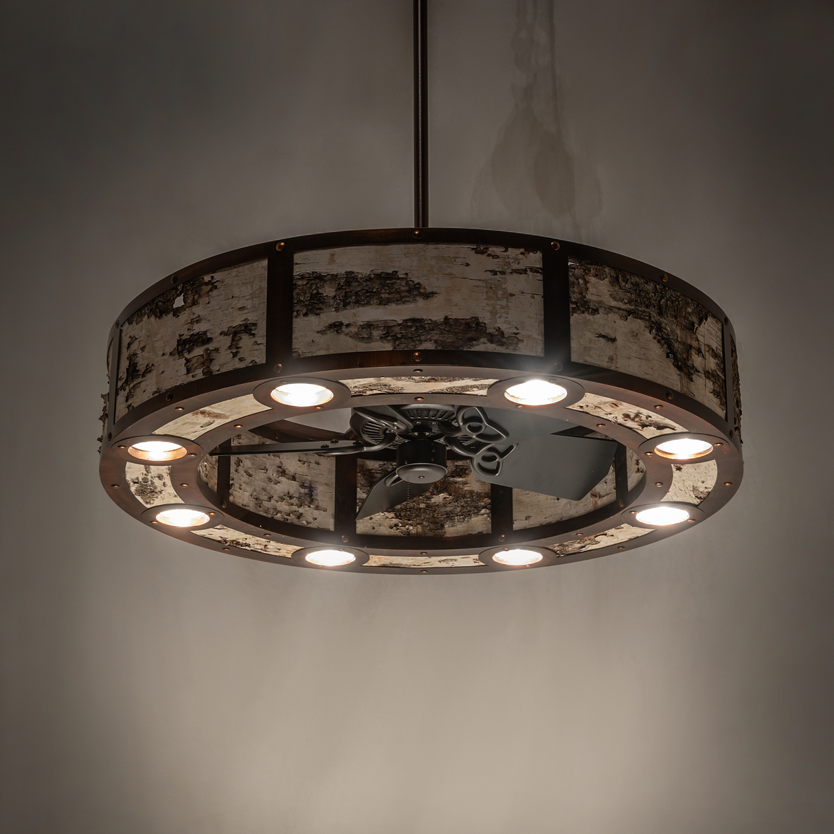 Ambient lit view of Birchwood Chandel-Air illuminating a rustic interior with warm light.