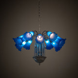Blue Tiffany Pond Lily 12 light chandelier lit in a dark room setting.