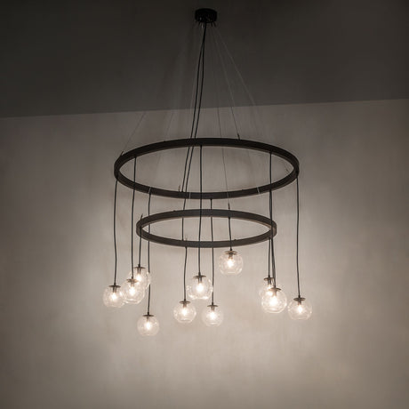 Ambient room view of lit Bola 12 light 2 tier chandelier with cascading clear glass orb pendants.