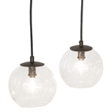 Detail view of two clear glass orb pendants suspended from chandelier in oil rubbed bronze finish.