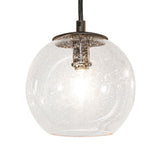 Closeup of clear glass orb pendant with Edison style bulb on Bola 12 light 2 tier chandelier.
