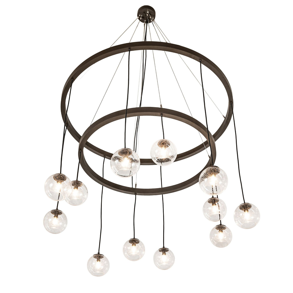 Lower angle view showing suspended bronze rings and clear glass orb pendants.