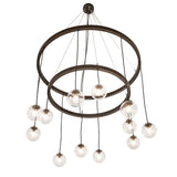 Lower angle view showing suspended bronze rings and clear glass orb pendants.