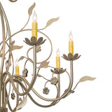 Close-up of Bordeaux chandelier candlelight with floral bobeche and curved metal arm.