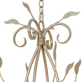 Close-up of Bordeaux chandelier top scrollwork and chain connection in satin gold finish.