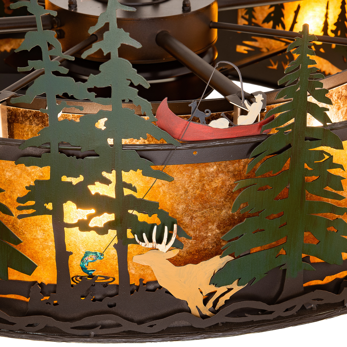 Detailed view of canoe, fish, and deer cutouts in forest scene.
