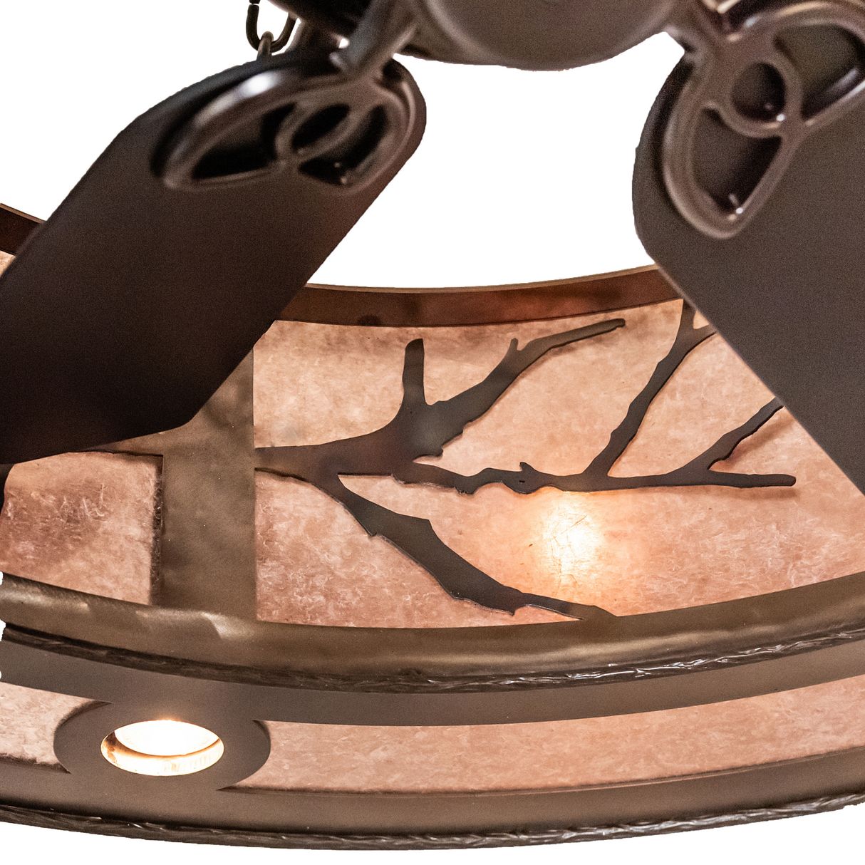 Close-up of integrated fan with visible downlights and branch pattern diffuser.