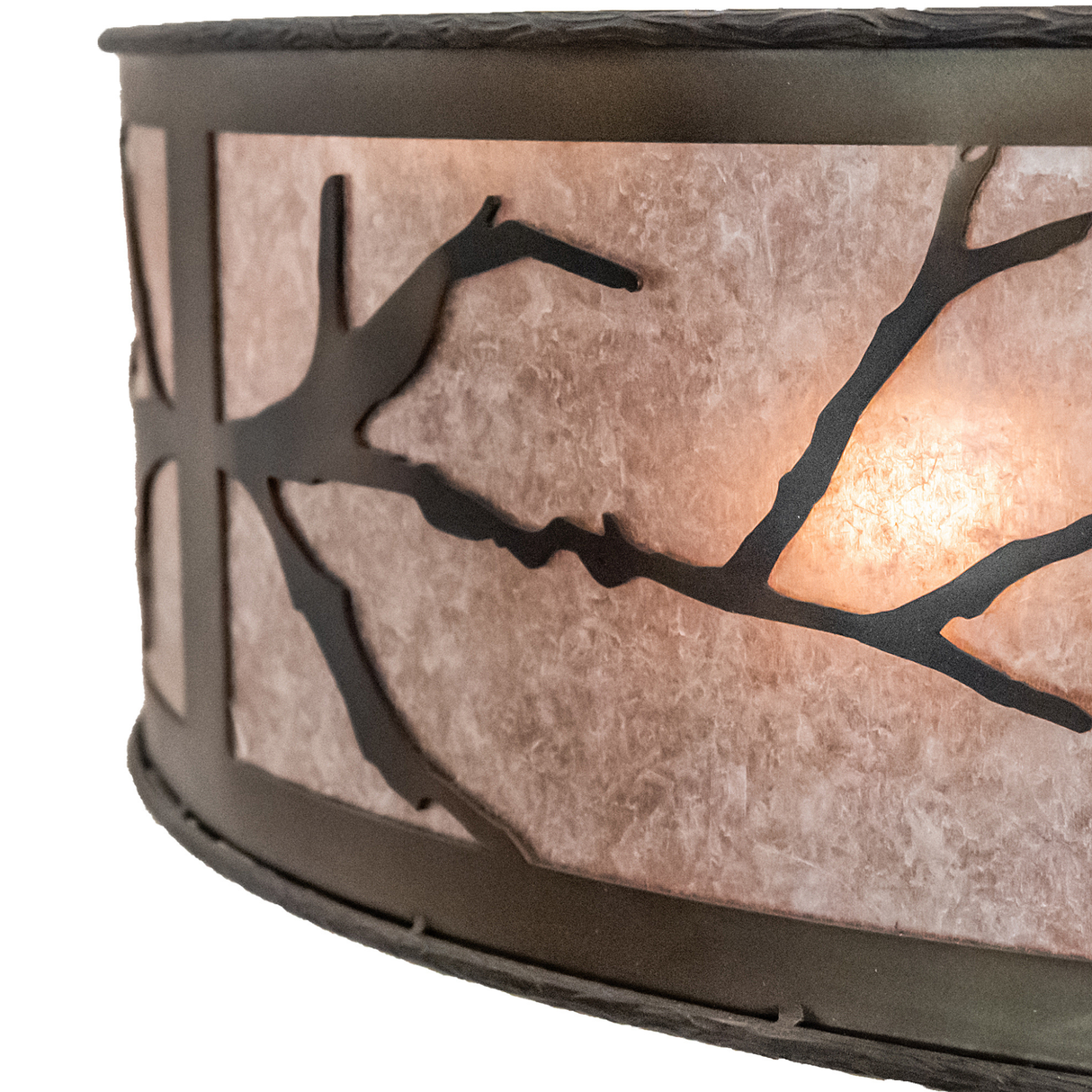 Close-up showing hand-forged branch silhouette on illuminated mica surface.