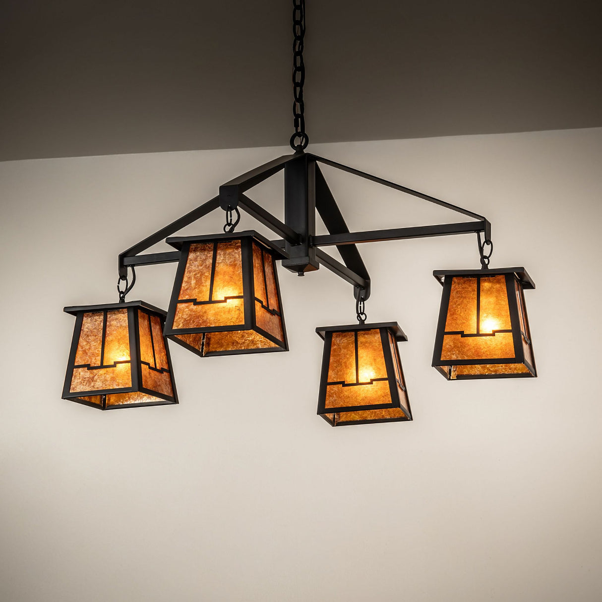 Bungalow valley view four-light chandelier shown installed with warm ambient lighting.