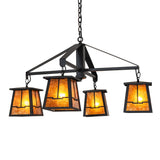 Lit view of four-light chandelier with amber mica shades illuminated.