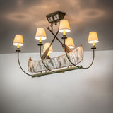 Ambient view of canoe-inspired chandelier, casting warm ambient light in rustic interiors.