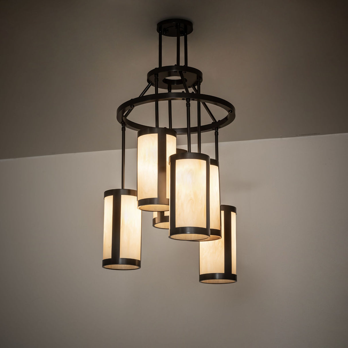 Cartier 6 light chandelier lit in a room setting showing warm ambient illumination.