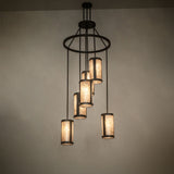 Ambient view of the Cartier 6-light cascading chandelier illuminating in a dark room.