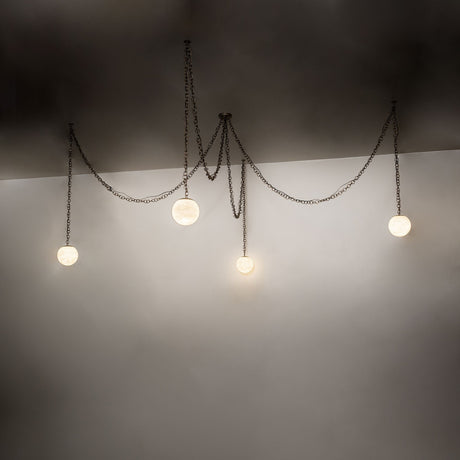 Ambient lighting view of Castiliolite Bola chandelier with softly glowing alabaster globes.