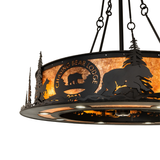 Edge close-up showing bear silhouette and handcrafted metal trees.