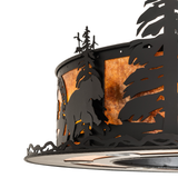 Close-up of bear and pine tree cutouts on amber mica Chasing Bear Lodge light.