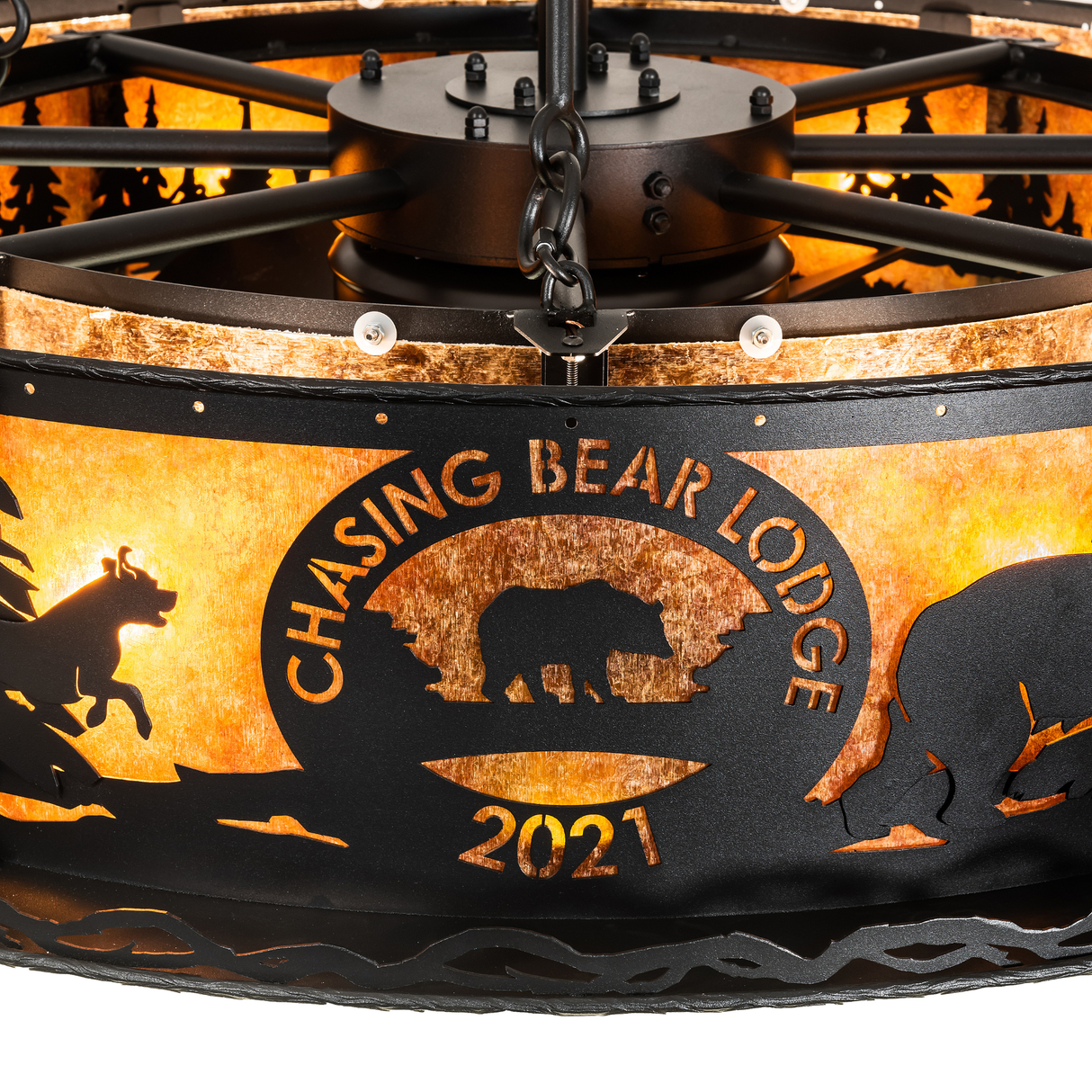 Close-up of Chasing Bear Lodge 2021 logo illuminated on amber mica.