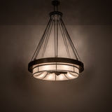 Illuminated Cilindro Ventura Chandel-Air casting warm light in a dark room setting.