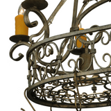 Intricate hand-forged scrollwork detail on Cira pot rack chandelier frame.