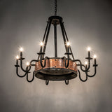 Ambient view of Costello chandelier showing warm glow and rustic copper detailing.