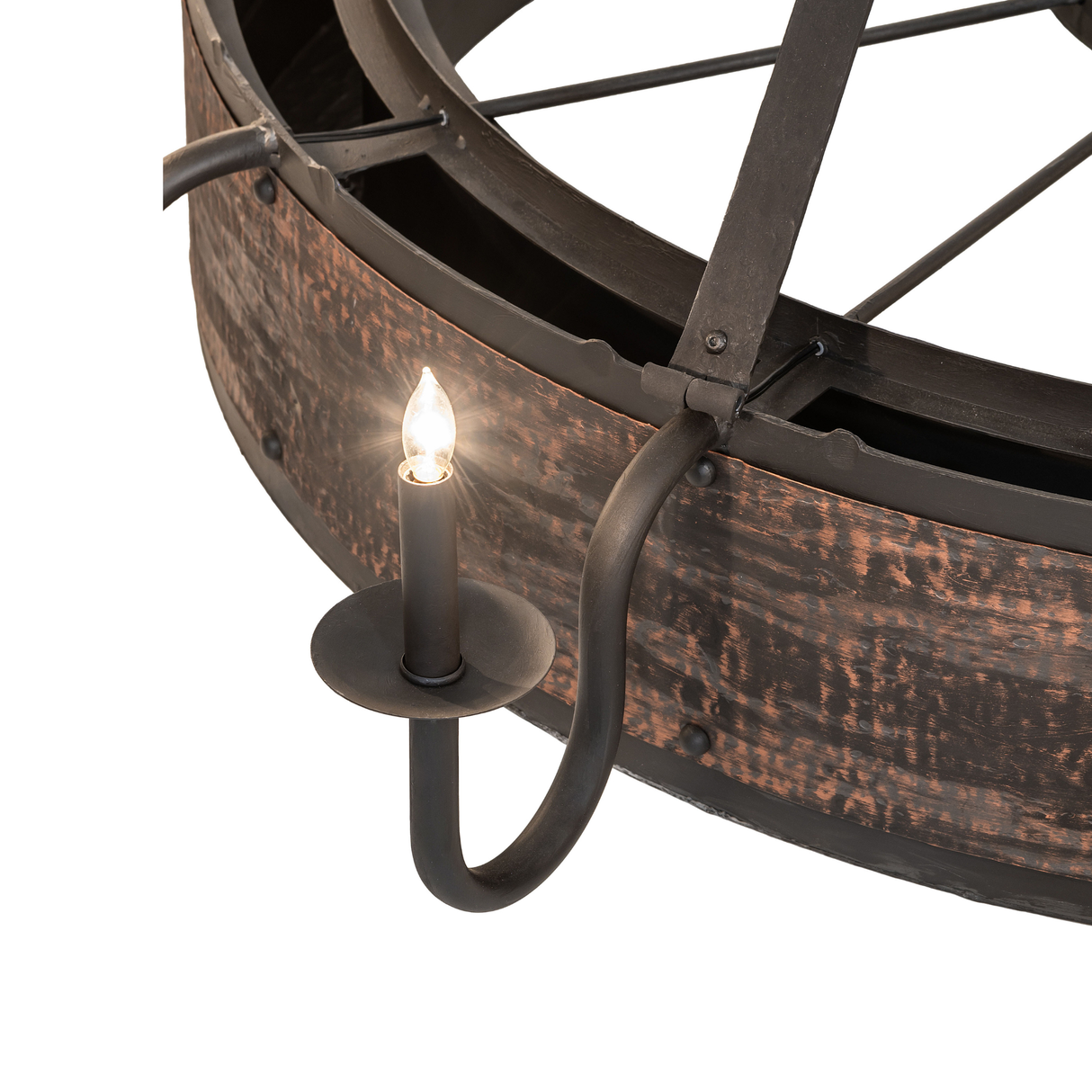 Detail of candlelight and curved arm in rustic chandelier.