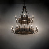 Dark room view of the Costello chandelier illuminated by candle-style lights.