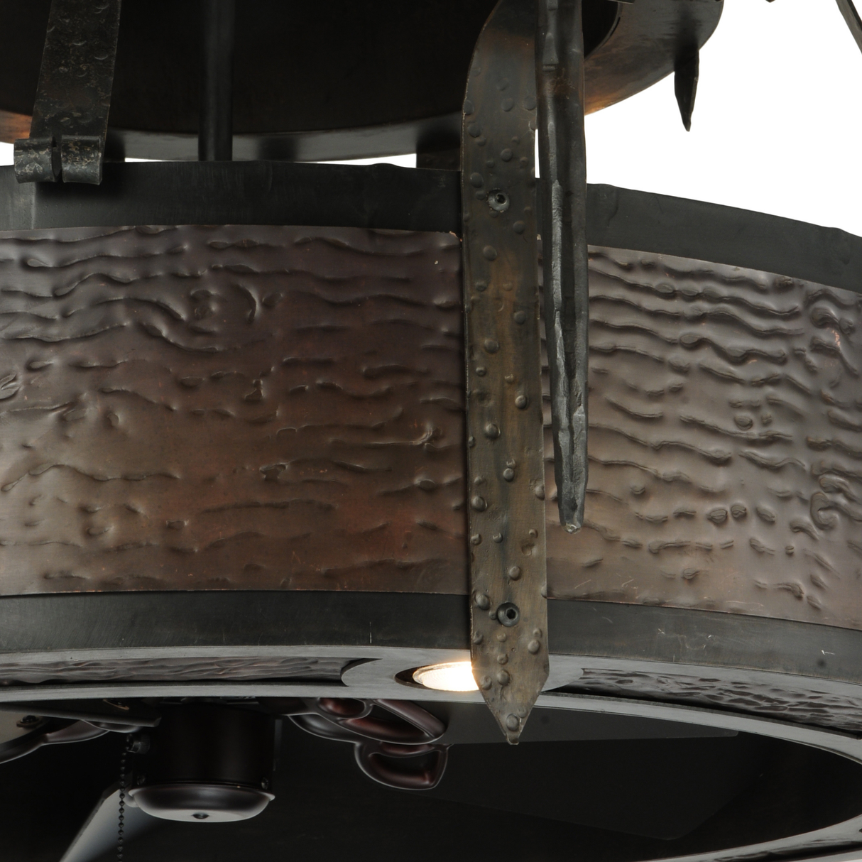 Close-up showing hammered steel texture and candlelight sconce design.