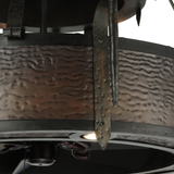 Close-up showing hammered steel texture and candlelight sconce design.