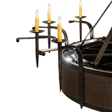 Close-up of clustered candle arms with glowing bulbs and hammered copper frame.