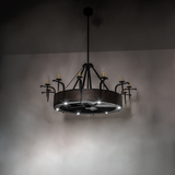 Softly illuminated chandelier view with rustic hammered metal detail.