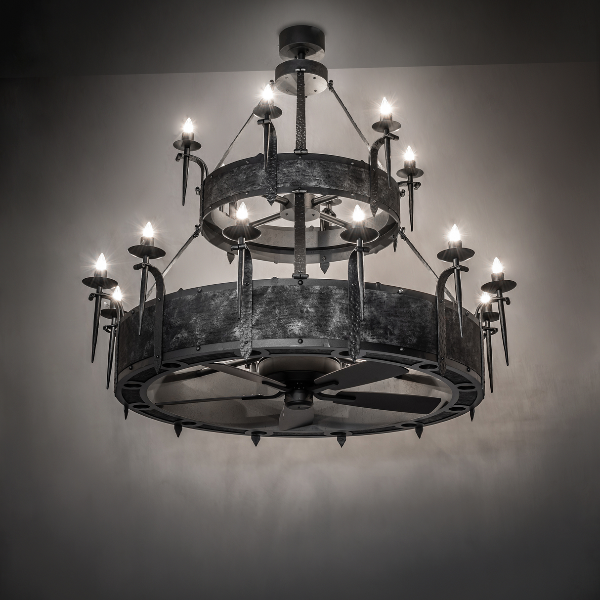 Angled view of illuminated Costello Two Tier Chandel-Air chandelier fan in ambient setting.