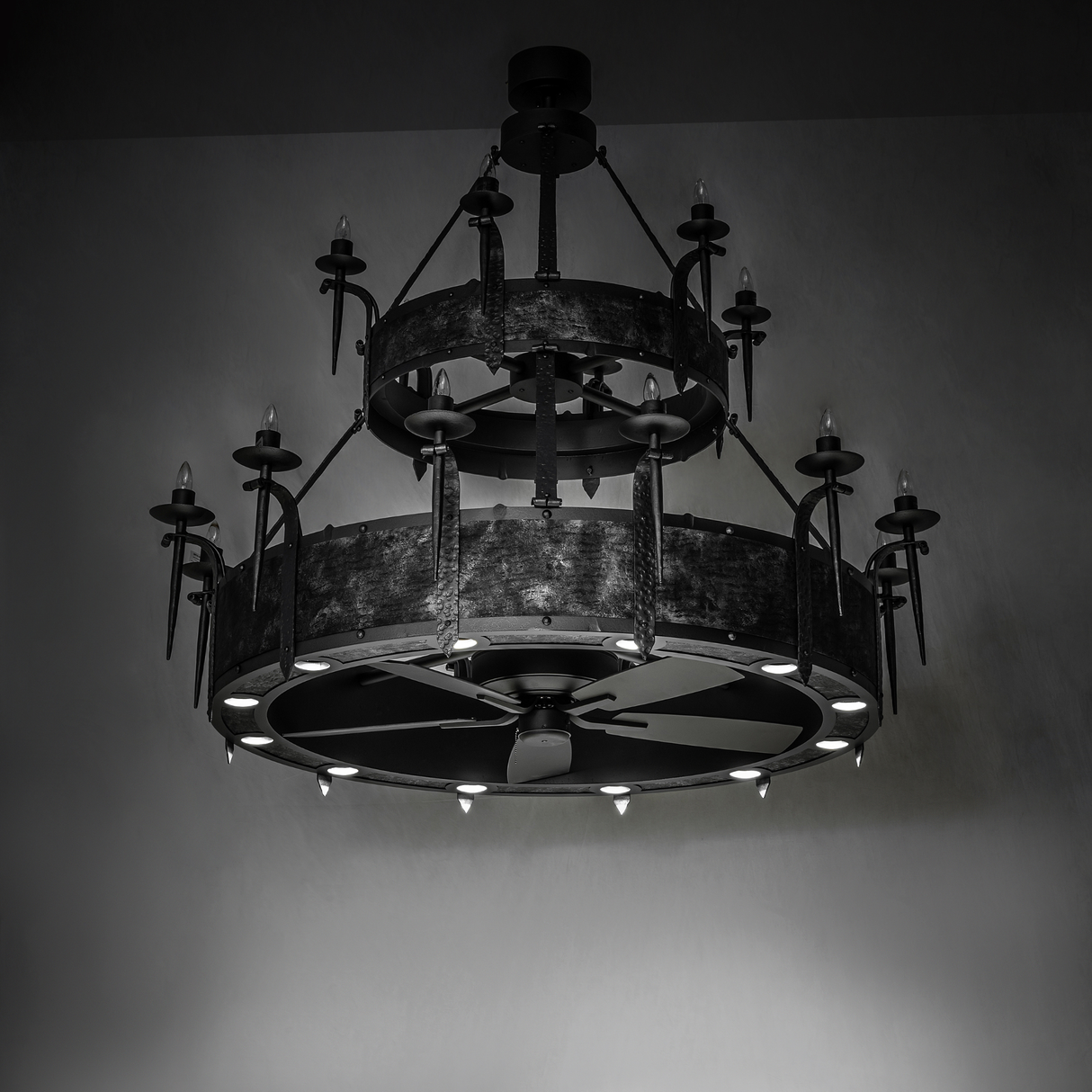 Angled view of unlit Costello Two Tier chandelier fan showing bold industrial frame.