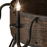 Close-up of single candlelight arm with rustic metal texture.