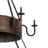 Close-up of wrought iron candle arms with glowing faux flame bulbs.