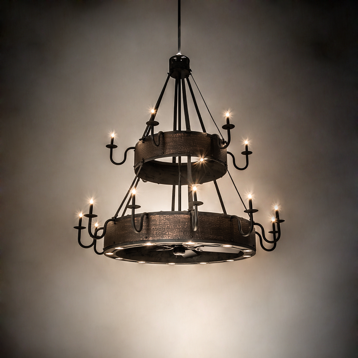 Ambient room view of Costello Two-Tier Chandel-Air glowing warmly.