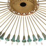 Close-up of Coyle chandelier hub with brushed brass finish and verdigris copper accents.