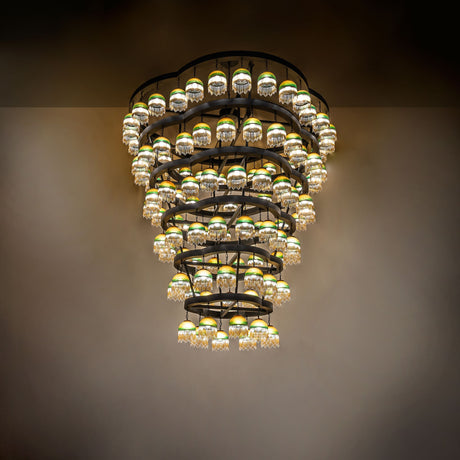 Ambient view of chandelier illuminated in a grand interior setting.