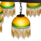 Close-up of green and amber glass shade with fringe detail.