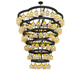 Lit view of 108 light chandelier with tiered circular frame.