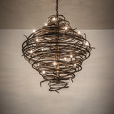 Cyclone chandelier creating warm ambient lighting with sculptural spiral iron design.