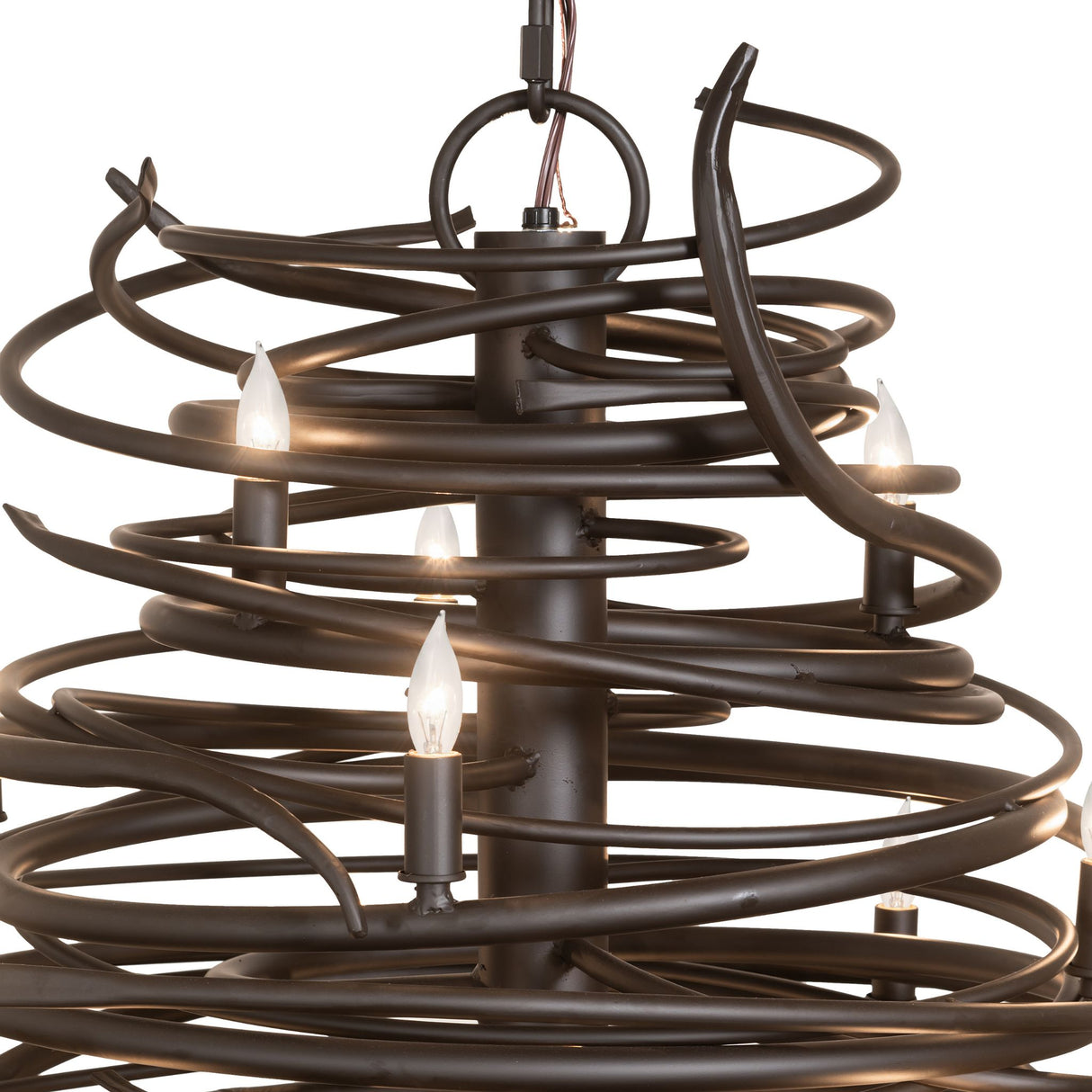 Close-up of Cyclone chandelier swirling iron bands and candle lights.