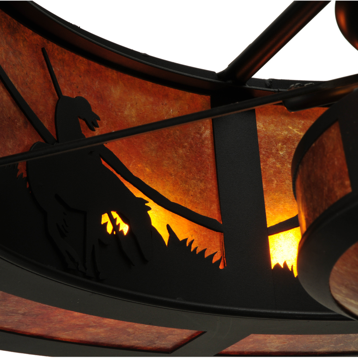 Close-up of cowboy and horse silhouette with warm mica backlight.