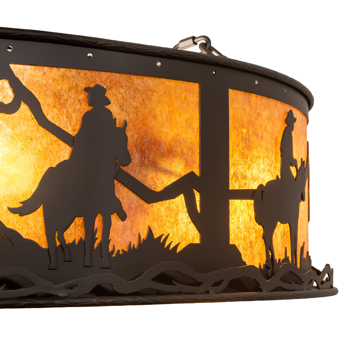 Detail of cowboy and horse cutout illuminated by amber mica glow.
