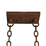 Close-up of ceiling canopy and hanging chain hardware.