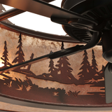 Closeup interior view showing fan blades and forest cutout shadows.
